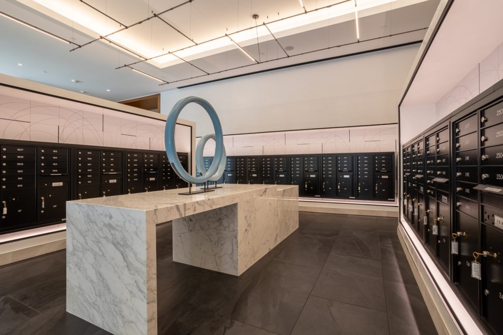 Interior shot of mail locker room with designer lighting and tile flooring